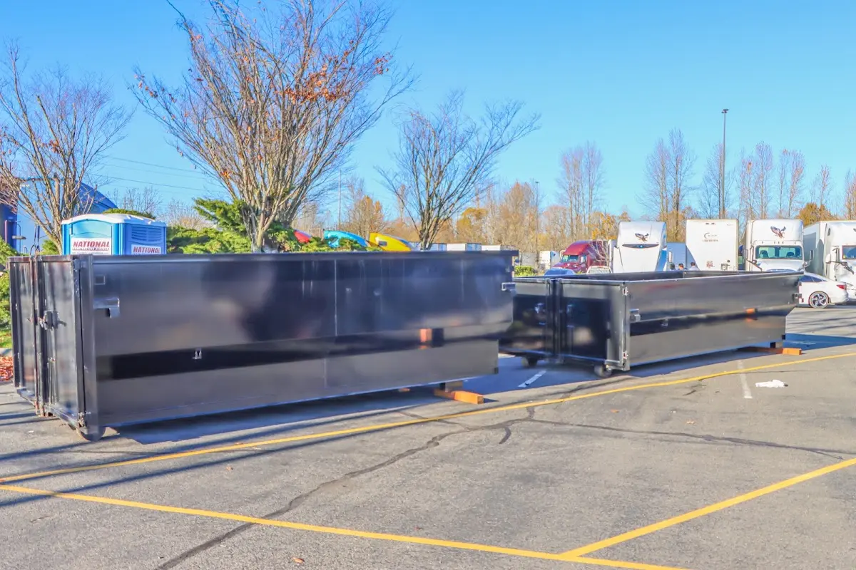 Professional dumpster rental service with roll-off container on residential driveway in Cedar Grove